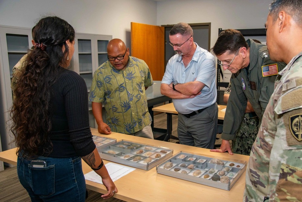 Navy Rear Adm. Greg Huffman, commander, Joint Task Force – Micronesia (second from right), and his staff are shown historical artifacts by staff of the University of Guam at its Cultural Repository building in April 2025.